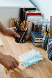 A person cleaning a desk